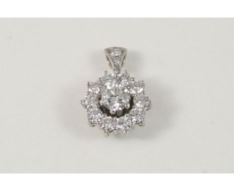 A DIAMOND CLUSTER PENDANT centred with a brilliant-cut diamond within a surround of smaller brilliant-cut diamonds, 1.5cm. di