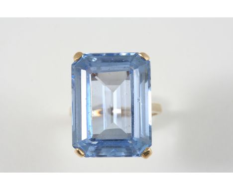 A SYNTHETIC SPINEL SINGLE STONE RING the rectangular-shaped synthetic blue spinel is set in 9ct. gold. Size K. 