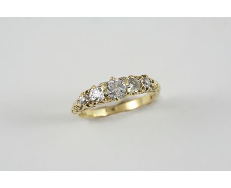 A DIAMOND FIVE STONE RING the five graduated old brilliant-cut diamonds are set in 18ct. gold. Size K 1/2. 