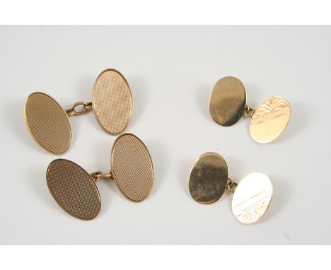A PAIR OF 9CT. GOLD CUFFLINKS of oval shape, with engine turned decoration, 5.7 grams, together with a pair of smaller 9ct. g