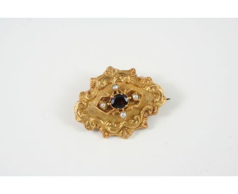 A VICTORIAN GARNET AND PEARL BROOCH the gold scrolling mount is centred with an oval-shaped garnet within a surround set with