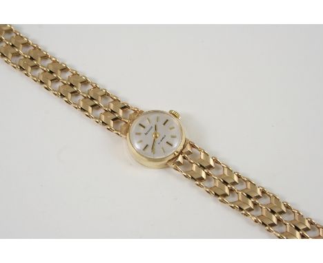 A LADY'S 9CT. GOLD WRISTWATCH BY ACCURIST the signed circular dial with baton numerals, on a gold fancy link bracelet with la