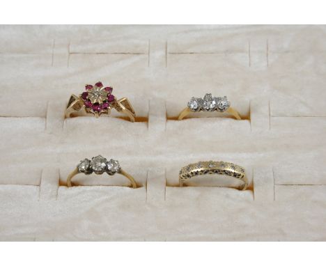 A DIAMOND THREE STONE RING set with three graduated old brilliant-cut diamonds, in gold, size I 1/2, together with another di