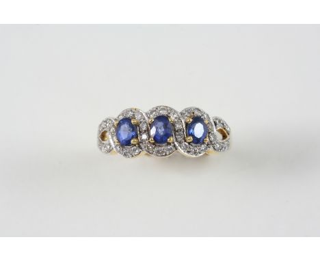 A SAPPHIRE AND DIAMOND TRIPLE CLUSTER RING the three oval-shaped sapphires are each set within a surround of circular-cut dia