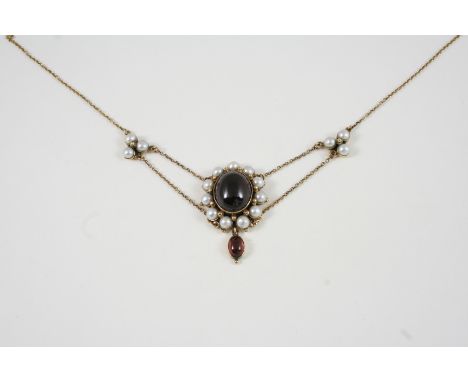 A GARNET AND HALF PEARL CLUSTER PENDANT the oval cabochon garnet is set within a surround of half pearls, suspending an oval 
