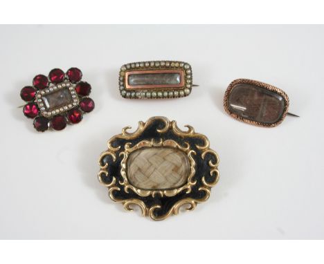 A GEORGIAN GARNET AND SEED PEARL MOURNING BROOCH the central compartment containing hair is set within a surround of seed pea