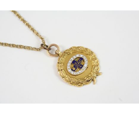 A 9CT. GOLD COMET CYCLING CLUB MEDALLION centred with blue and white enamel badge for the cycling club within a laurel wreath