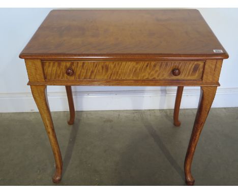 A 19th century satinwood writing desk with a pull out drawer revealing a writing slope, inkwell and pen tray