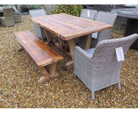 A Bramblecrest Kuta 180cm table with a bench and four armchairs