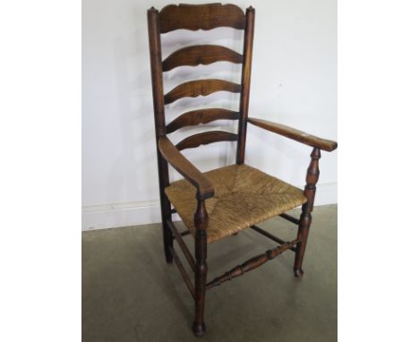 A ladder back armchair with a rush seat