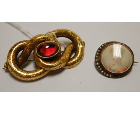 A Victorian pinchbeck and garnet set brooch; together with a seed pearl set miniature portrait brooch (2)
