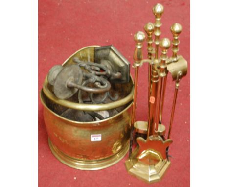 An early 20th century brass helmet shaped coal scuttle together with a brass twin sconce wall light fitting and brass compani