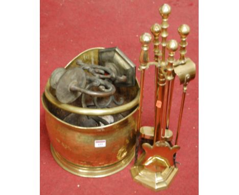 An early 20th century brass helmet shaped coal scuttle together with a brass twin sconce wall light fitting and brass compani