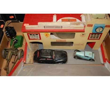 A mid-20th century painted wooden model of a garage and forecourt; together with a Chad Valley Harborne tinplate toy car, Tri