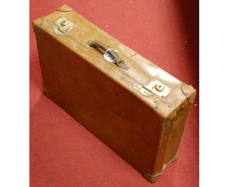 An early 20th century leather clad travelling trunk, with brass lever locks and silk lined interior; together with one other 