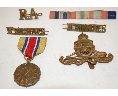 A United States Army Reserve medal, together with a Royal Artillery cap badge and Royal Signals shoulder titles etc.