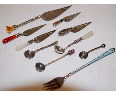 A collection of white metal and silver bookmarks in the troughs, to include mother of pearl and coral handled examples; and o
