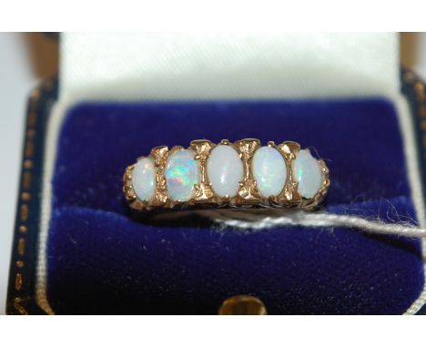 A 9ct gold cabochon opal set five stone ring, size N 