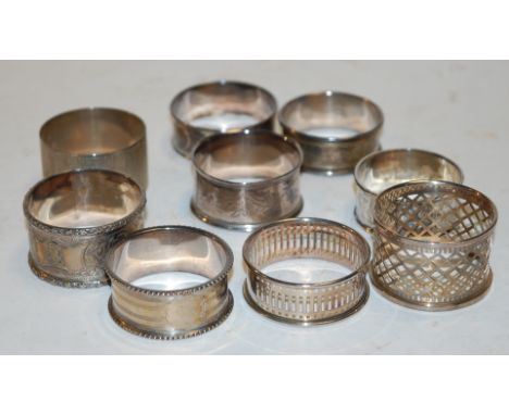Nine various silver napkin rings to include; pierced, engraved and engine turned examples