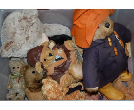 A figure of Paddington bear in orange hat, blue duffel coat and yellow Dunlop wellies together with various other children's 