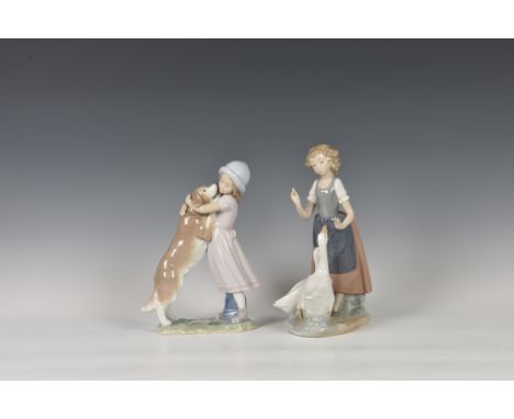 A Lladro figurine 'A Warm Welcome', modelled as a girl and dog, printed and stamped marks, 10in. (25.3cm.) high, together wit