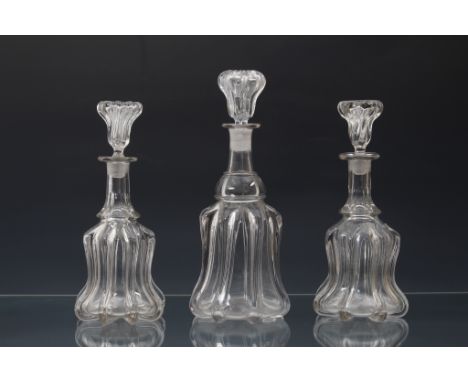 A pair of Victorian glass bell decanters, the pillar moulded bodies with polished pontils, below panel cut necks and matching