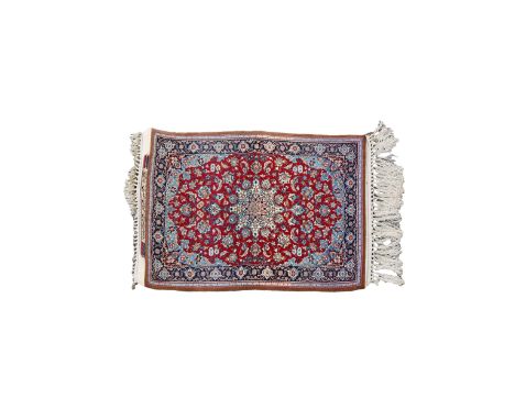 A signed silk fringe Isfahan rug, with a central medallion on red ground with floral spandrels and borders, converted to wall