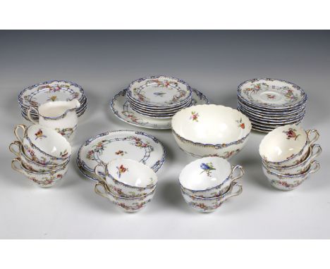 A Coalport porcelain part tea service, comprising ten teacups and saucers, twelve tea plates, two stands, milk jug, cake plat