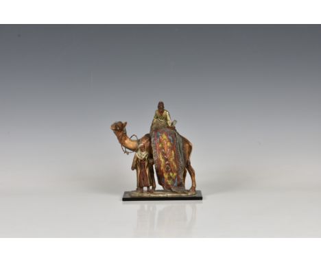 An Austrian Bergman style cold painted spelter table lighter in the form of a camel and two Arabian rug sellers, early 20th c