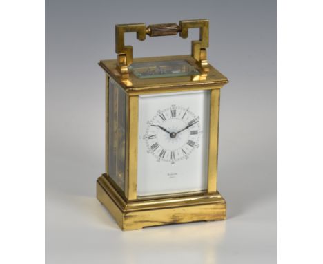 A French gilt brass carriage clock, early 20th century, signed to the white, Roman enamel dial by the retailer Barlow of Pari