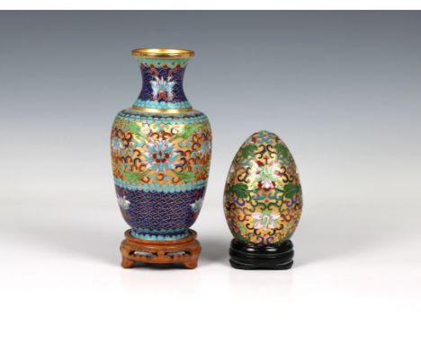 A 20th Century Chinese cloisonné and champlevé enamel vase, decorated with lotus flowers and scrolling foliage, 7 inches high