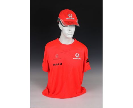 A Vodafone McLaren Mercedes official F1 team bright orange Hugo Boss large T-Shirt, signed below neck line in black marker by