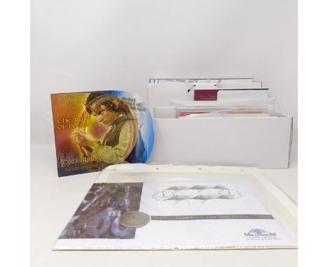 A set of Lord Of The Rings commemorative coins, in a wallet and other commemorative coins