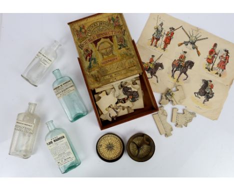 Peacock's Improved Double Dissection jigsaw puzzle, a miners lamp, brass compass, collection of bottles and jars, and a large