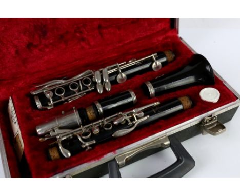 Boosey and Hawkes clarinet in fitted case, and a violin in Withers and Son case, along with a mid-century magazine rack      