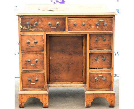 Walnut kneehole desk, with leather writing surface above eight drawers on bracket feet, H76 x W76 x D51cm        