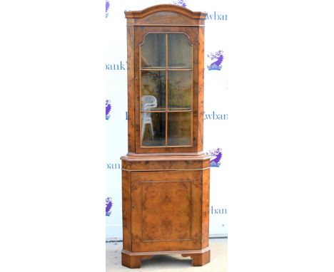 Reproduction burr walnut veneer corner cabinet, glazed door above cupboard door on bracket feet, H188 x W66cm        