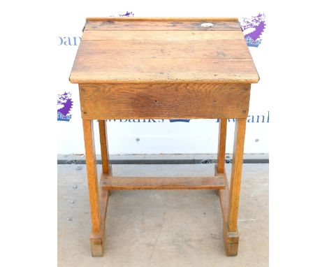 Vintage oak school desk, the hinged top with ceramic inkwell marked 'Bennet Furnishing Co. Ltd, Glasgow', H82 x W62 x D50cm  