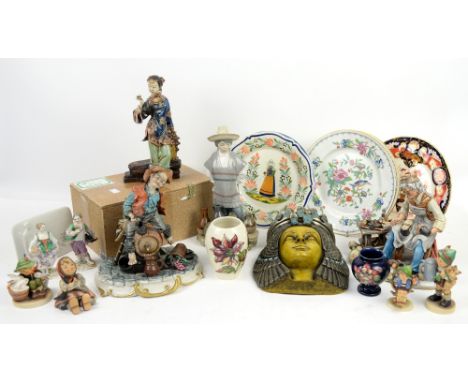 Lladro figure of a boy in poncho selling pots, two continental figures with crossed swords marks to the base, two Moorcroft v