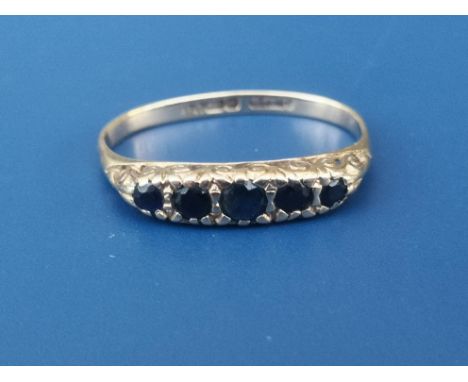 A five stone graduated sapphire 9ct gold ring - shank misshapen.  