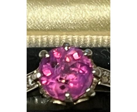 A certified natural pink Sri-Lankan sapphire solitaire ring, the claw set circular cut sapphire weighing approximately 1.45 c