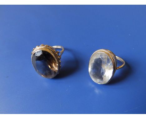 A smoky quartz single stone 9ct gold ring and one other. (2)