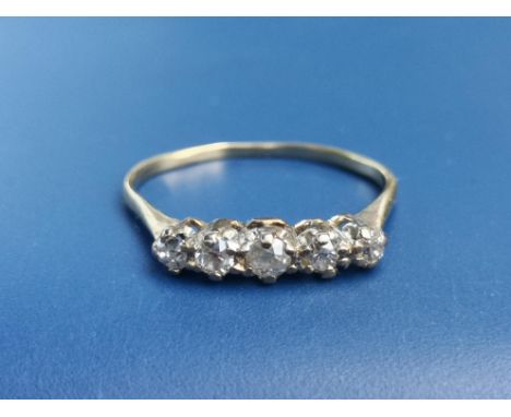 A small five stone graduated diamond ring on (buckled) yellow metal shank.  Finger size N.