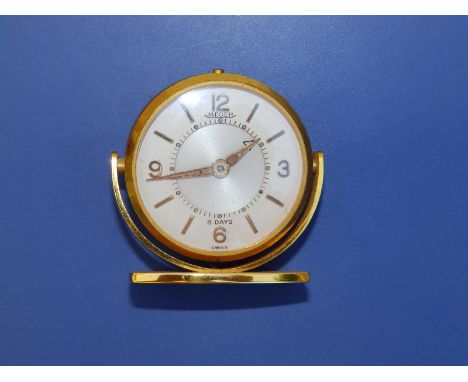 A boxed gilt metal Jaeger 8 Day alarm clock, case diameter 46mm.