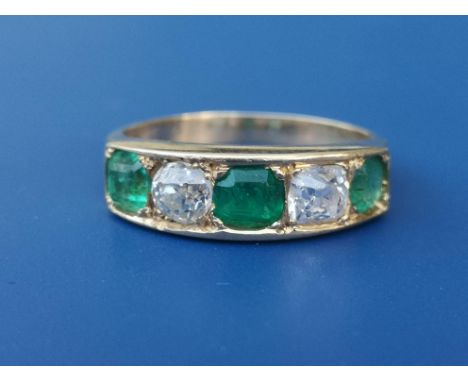 A five stone emerald &amp; old cut diamond ring in yellow metal.  Finger size N.