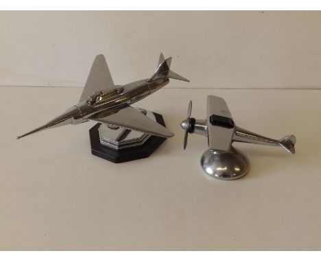 An art deco chrome plated jet fighter lighter, 9" across and a monoplane lighter. (2)