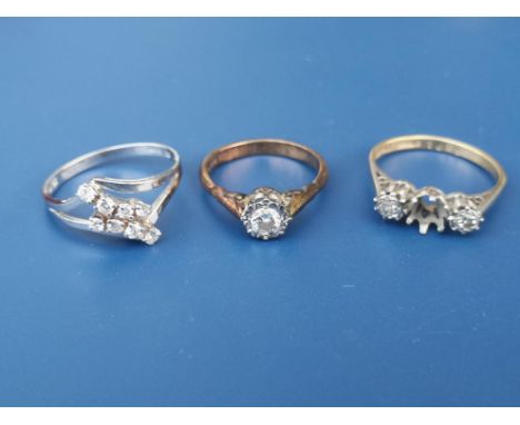 An illusion set diamond solitaire ring in 18ct gold and two other diamond rings - one missing stone. (3)