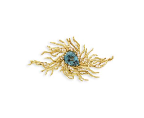 BROCHE TOURMALINE ET DIAMANTSDe forme asymétrique, sertie au centre d'une tourmaline bleue de forme poire, accentuée de diama