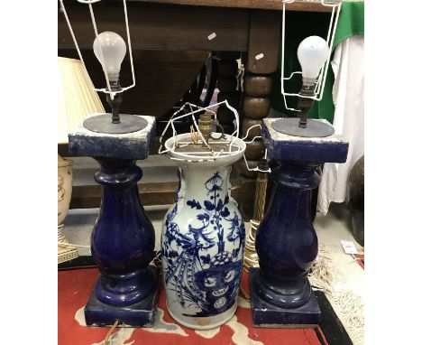 A pair of blue glazed pottery baluster column table lamps, a modern Chinese blue and white vase type table lamp and a treacle