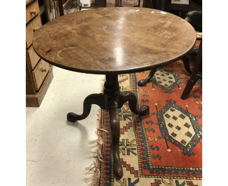 A 19th Century oak occasional table, the thin circular top on a tapering pedestal to tripod base